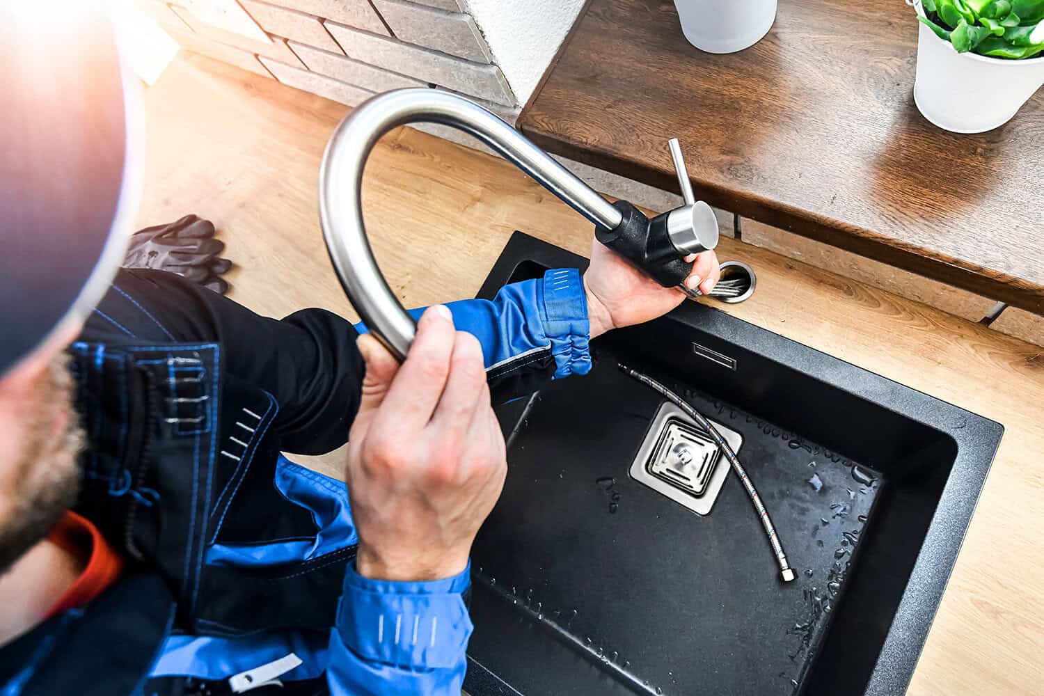 Water leak repair in kitchen sink by professional plumber.