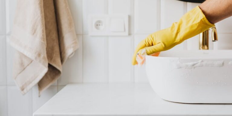 Professional cleaning a clogged sink drain