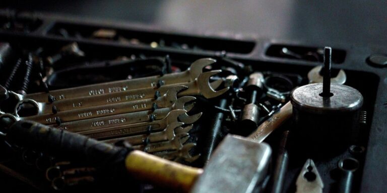 Set of plumbing wrenches and tools in a toolbox