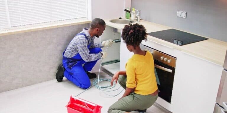 Professional plumber cleaning a pipe drain clog and unclogging a sewer line